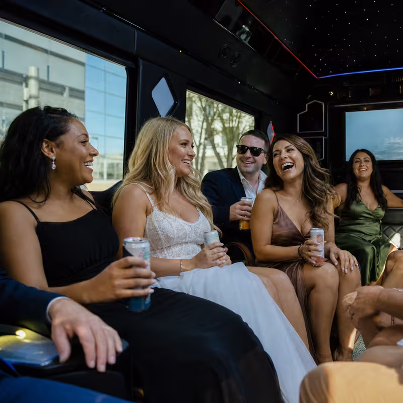 Party bus interior with wraparound leather seating and LED lighting in St Paul