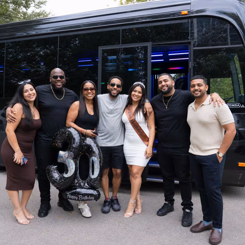 Group boarding a white charter bus for Birthday Transportation transportation in St Paul
