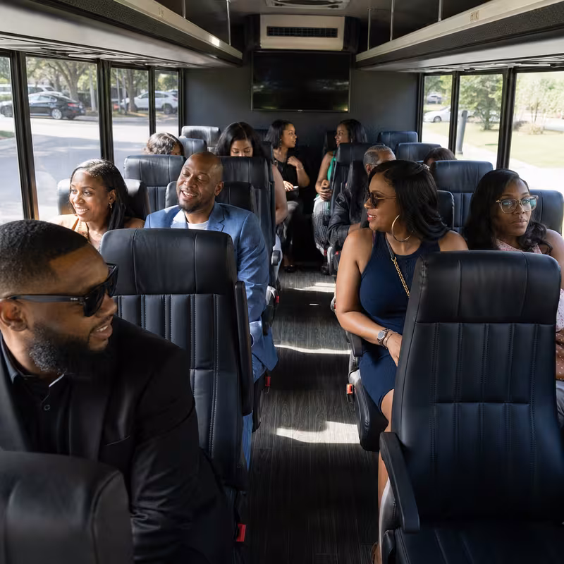 Group boarding a white charter bus for Private Event Transportation transportation in St Paul