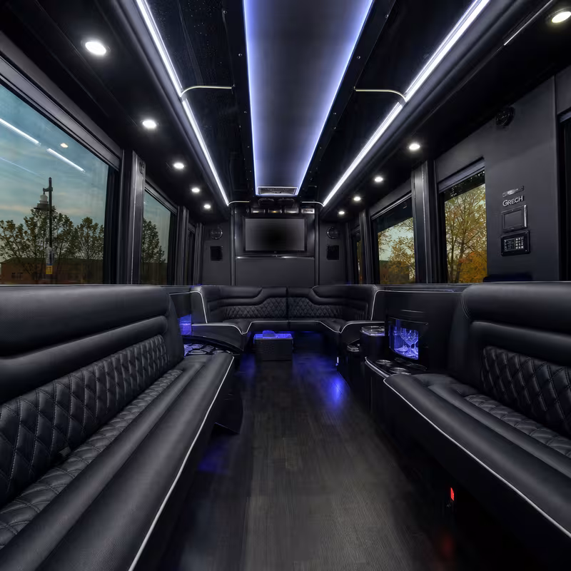 Party bus interior with wraparound leather seating and LED lighting in St Paul