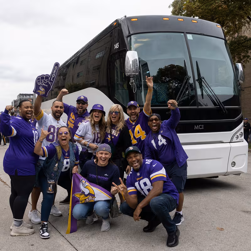 Passengers loading luggage while boarding an St Paul group shuttle