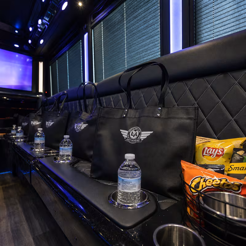 Party bus interior with wraparound leather seating and LED lighting in St Paul